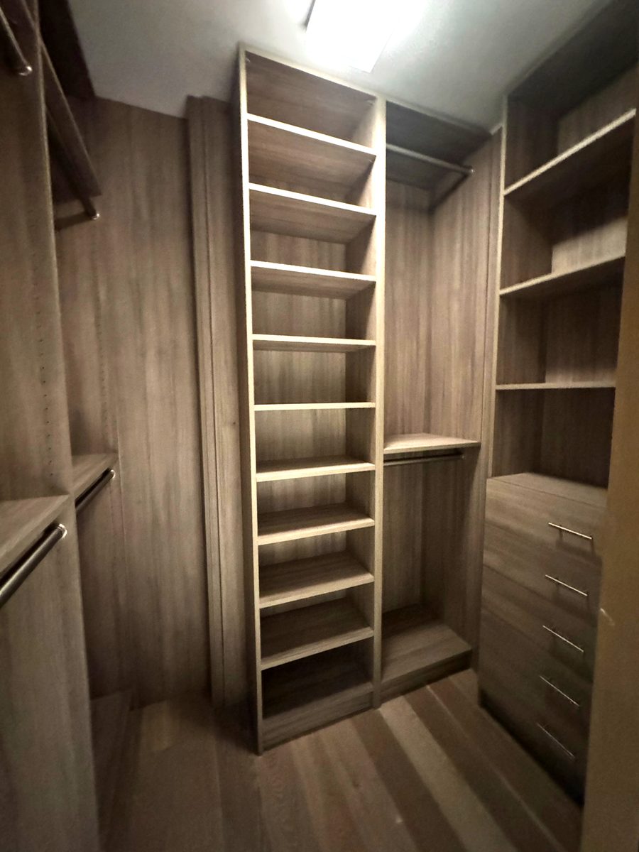 Walk in closet system in driftwood TFL with central shoe tower, hang sections and drawer stack