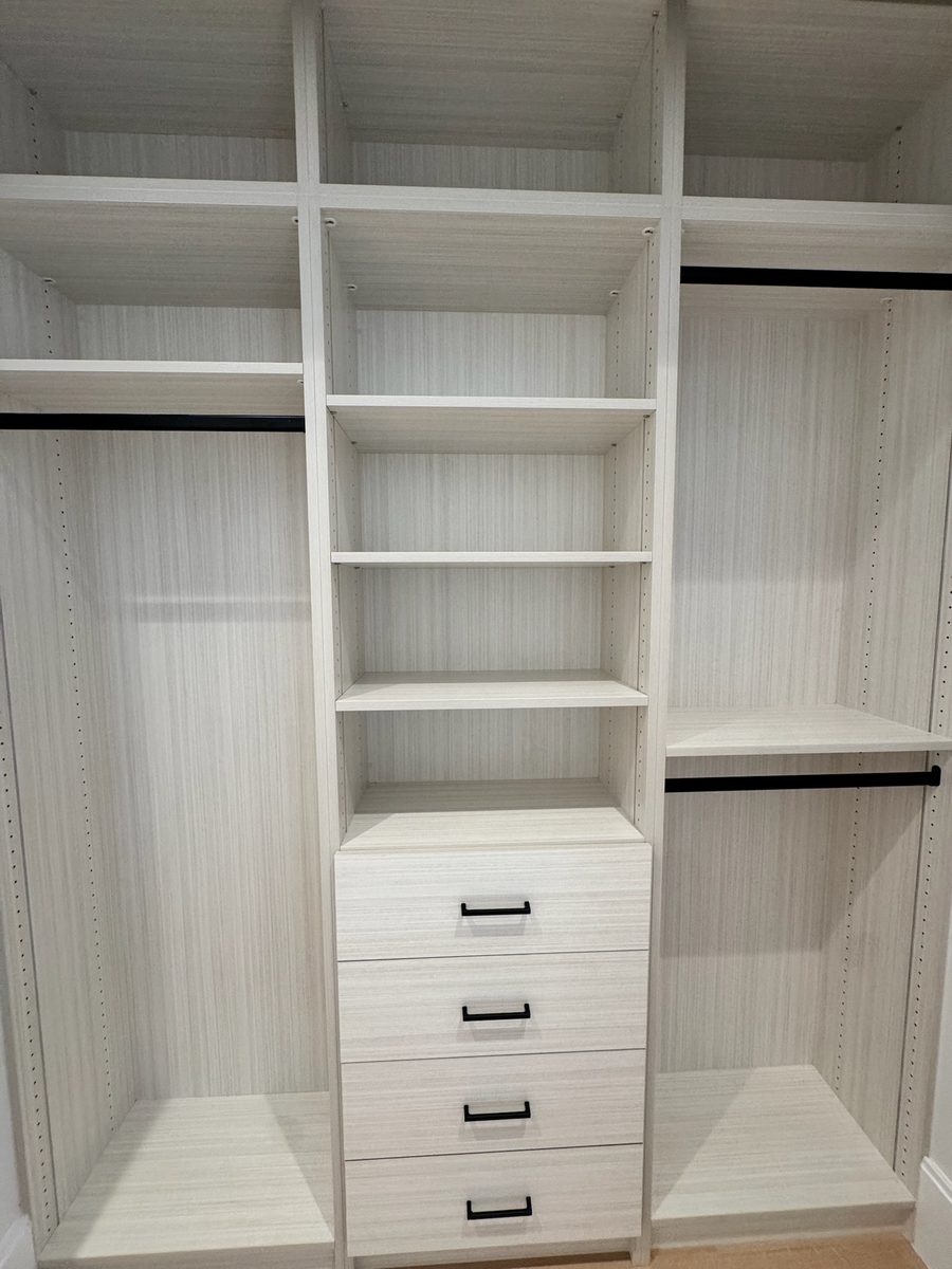 Walk in closet system in linen texture TFL with central drawer stack and matte black pulls